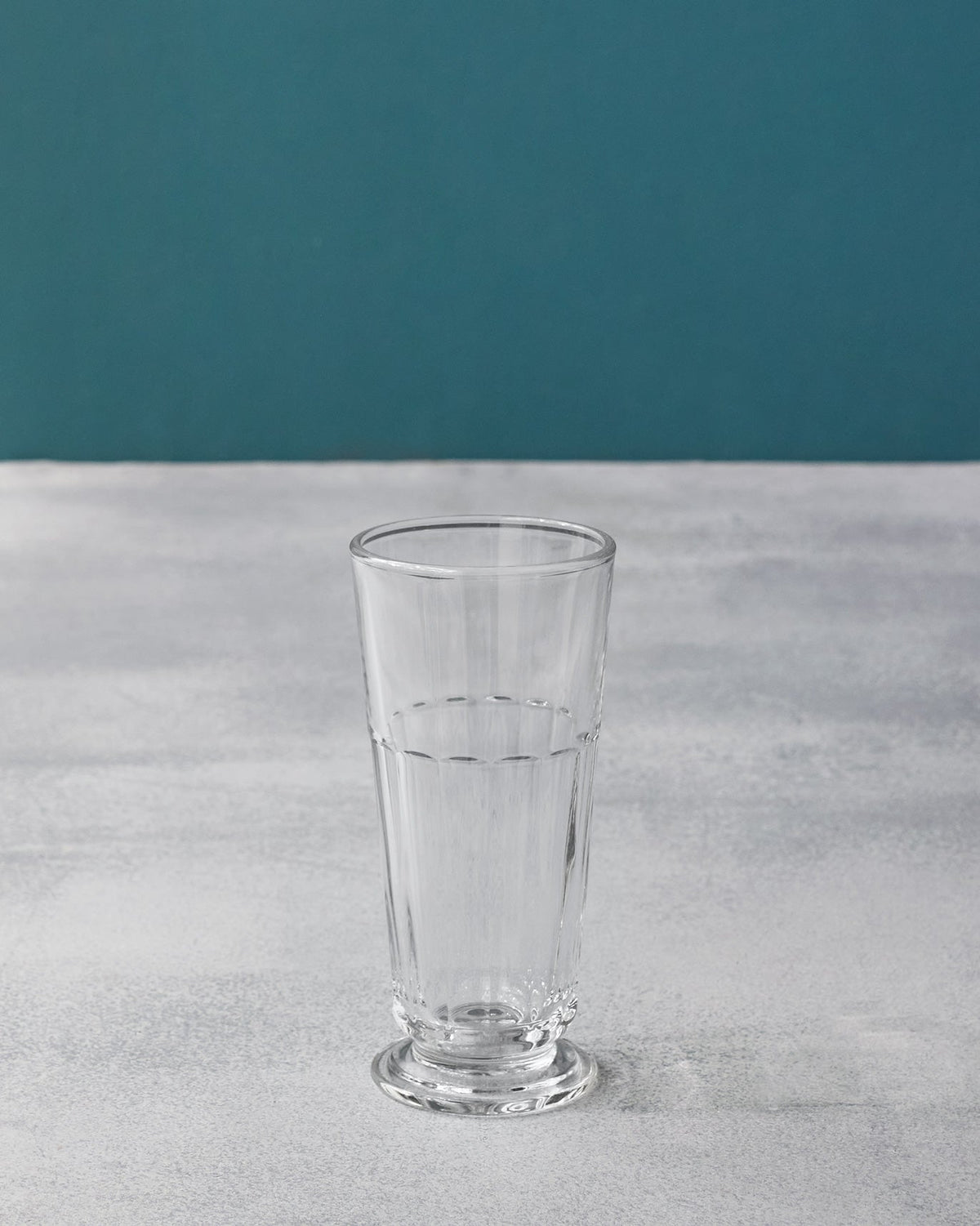 Tall clear Mahi beer glass with vertical fluting and a footed base.