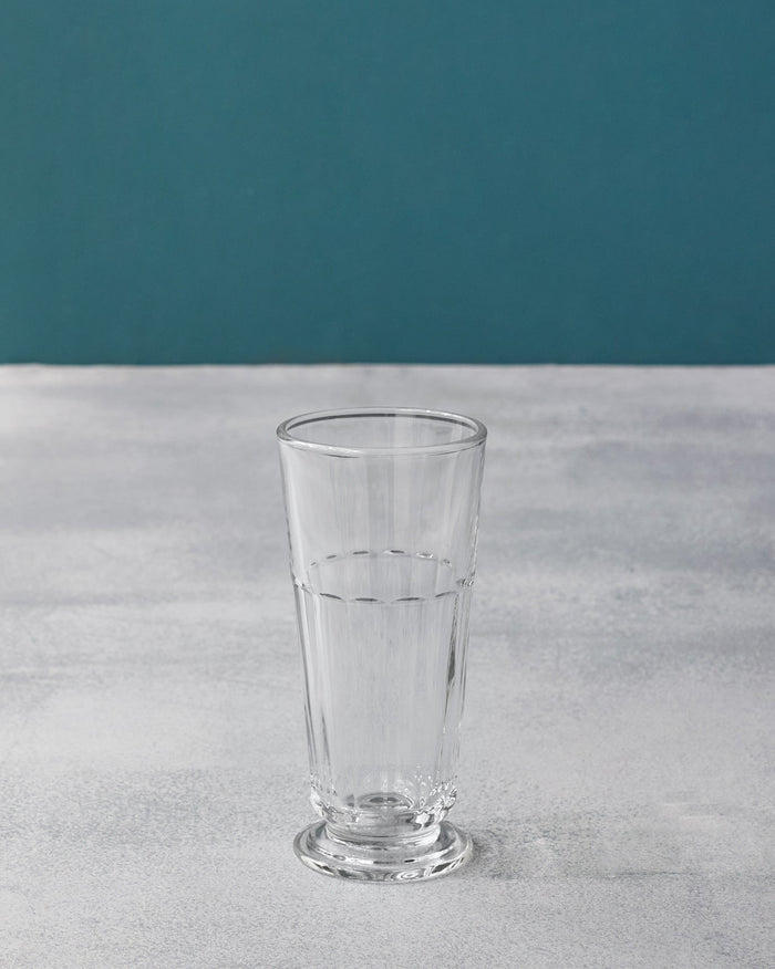Tall clear Mahi beer glass with vertical fluting and a footed base.