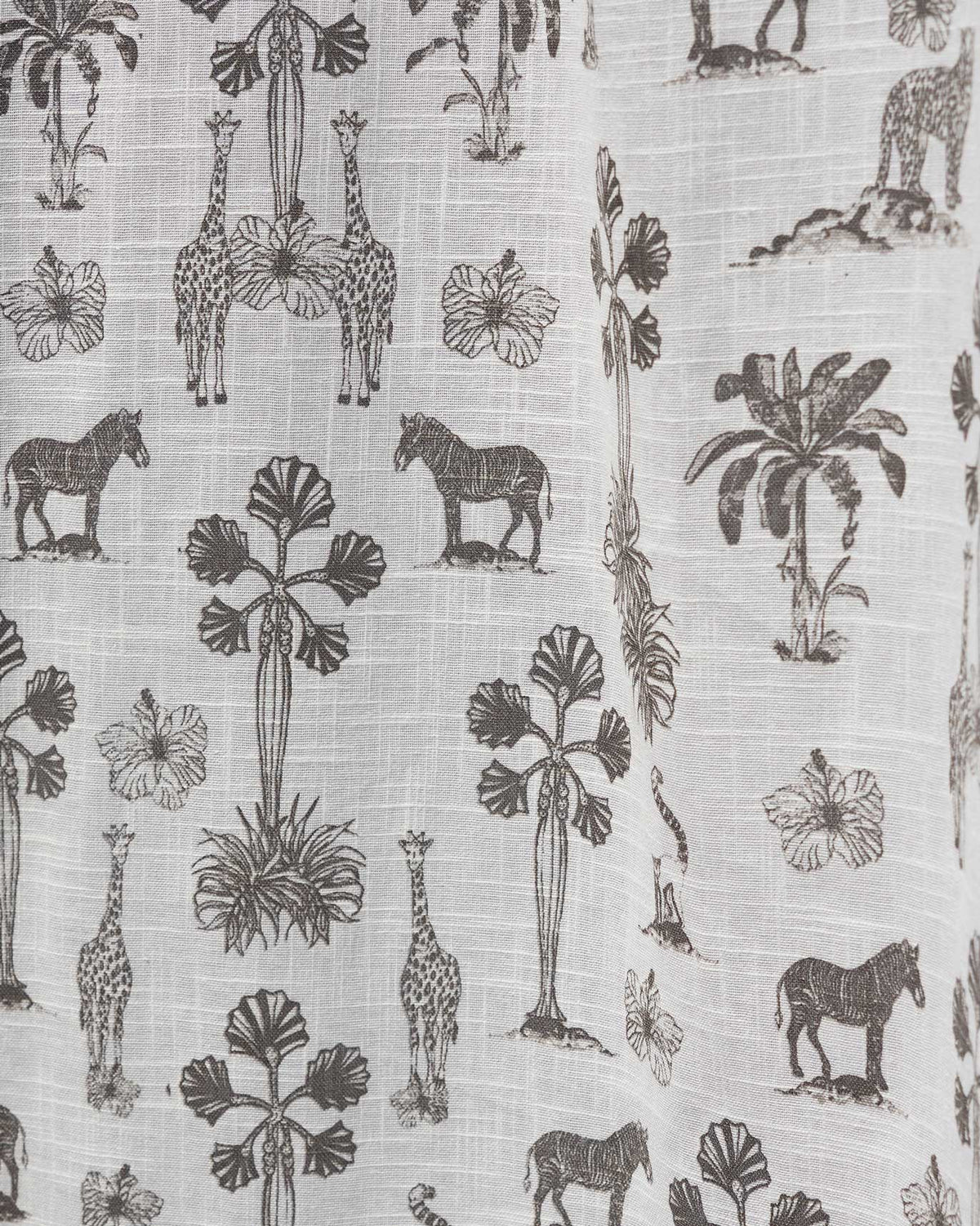 Close-up of the Twilight Shower Curtain showing its zebra, giraffe and palm print.