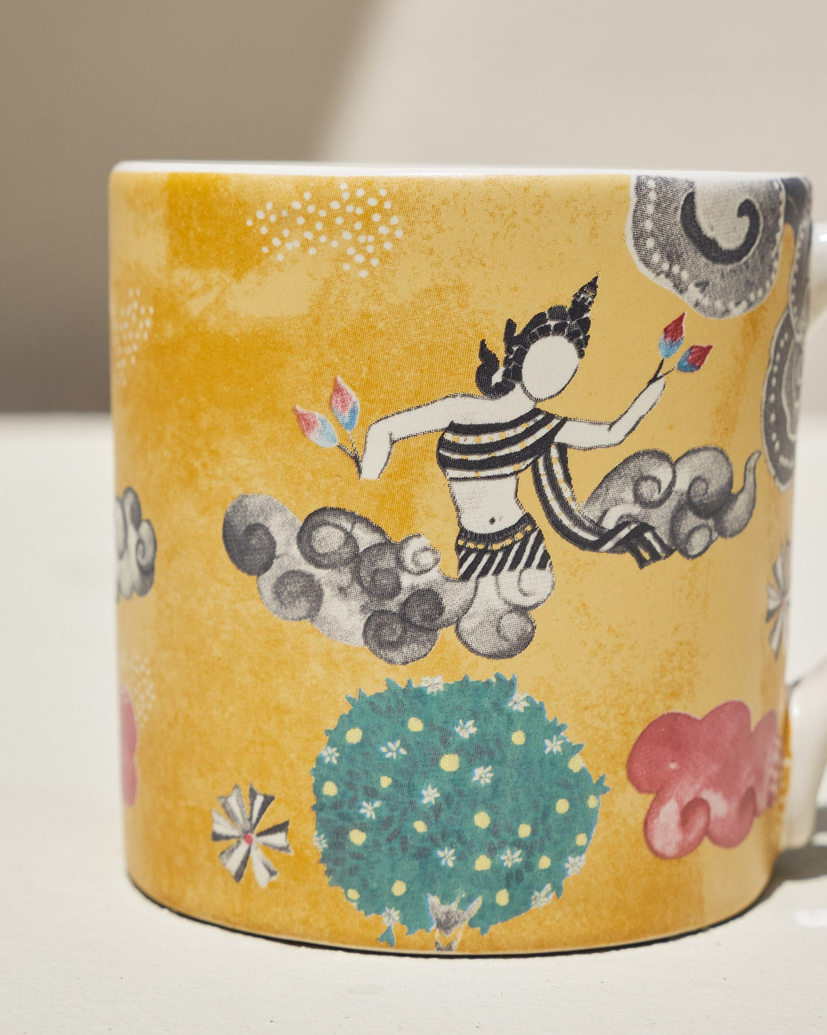 Close-up of the Bliss Mug showing a figure among grey clouds on yellow.