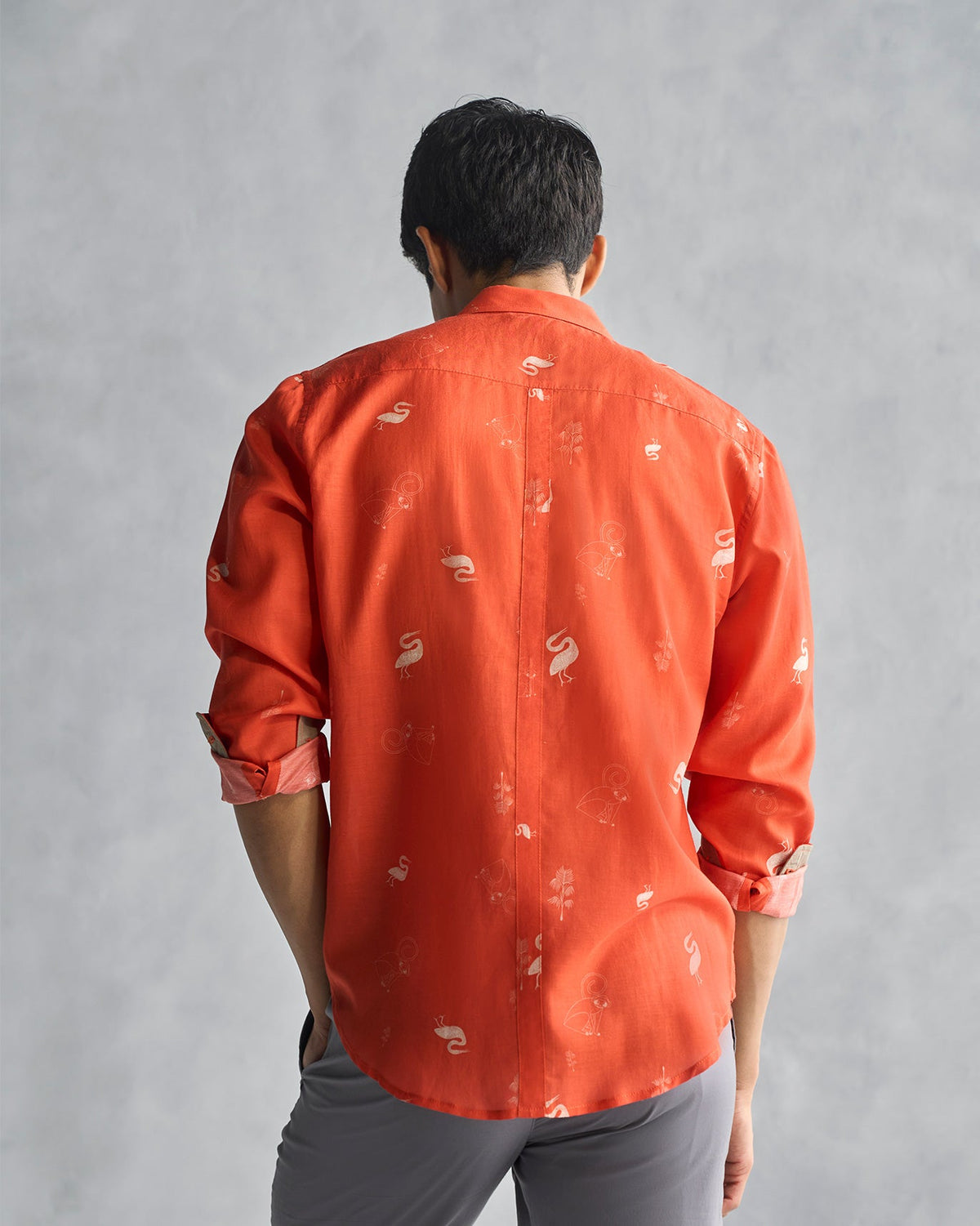 Back of a rust Paradise Shirt worn by a person.