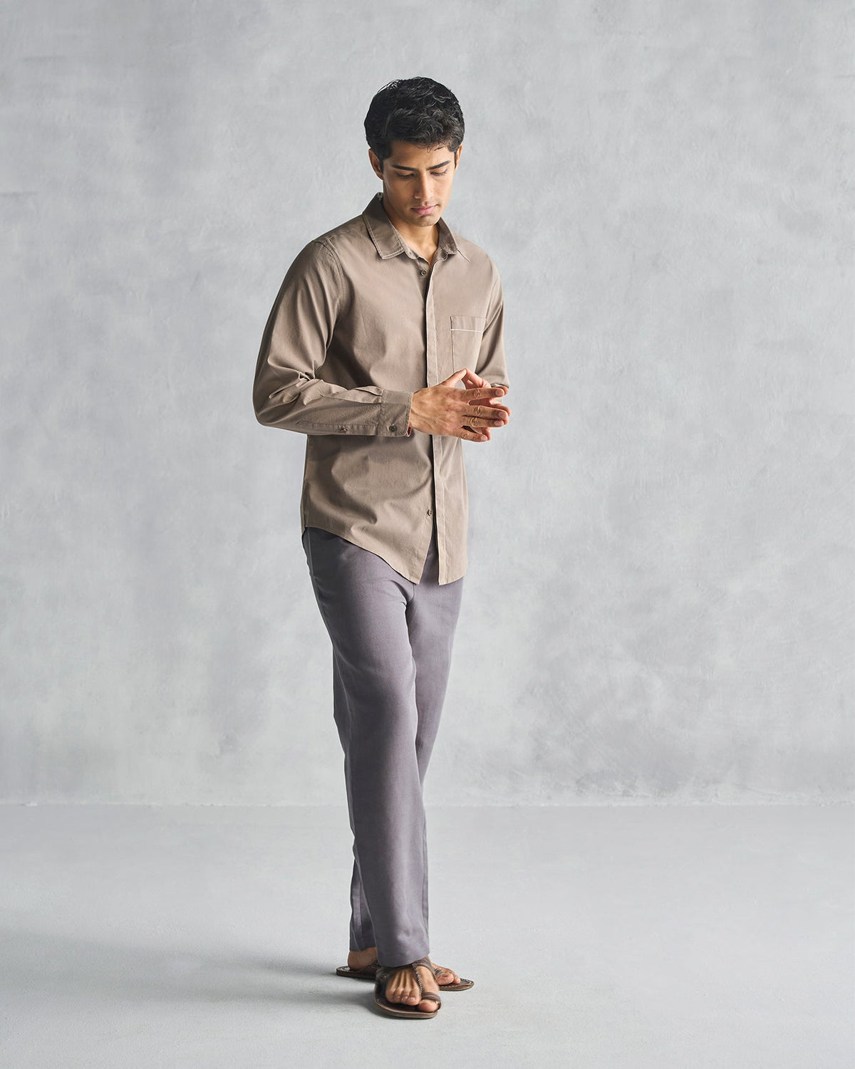 Person wearing an oak brown Plateau shirt, shown full length.