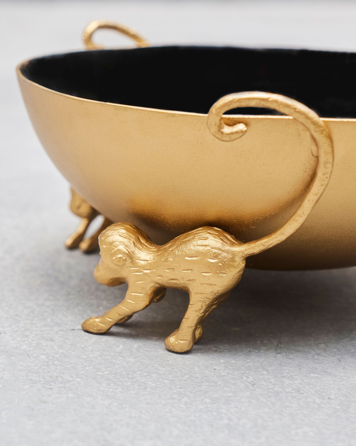 Close-up of a gold monkey foot on the Brolly Deco Bowl.