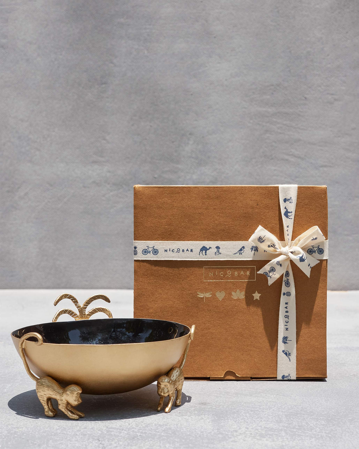 Brolly Deco Bowl beside a kraft gift box tied with a printed ribbon.