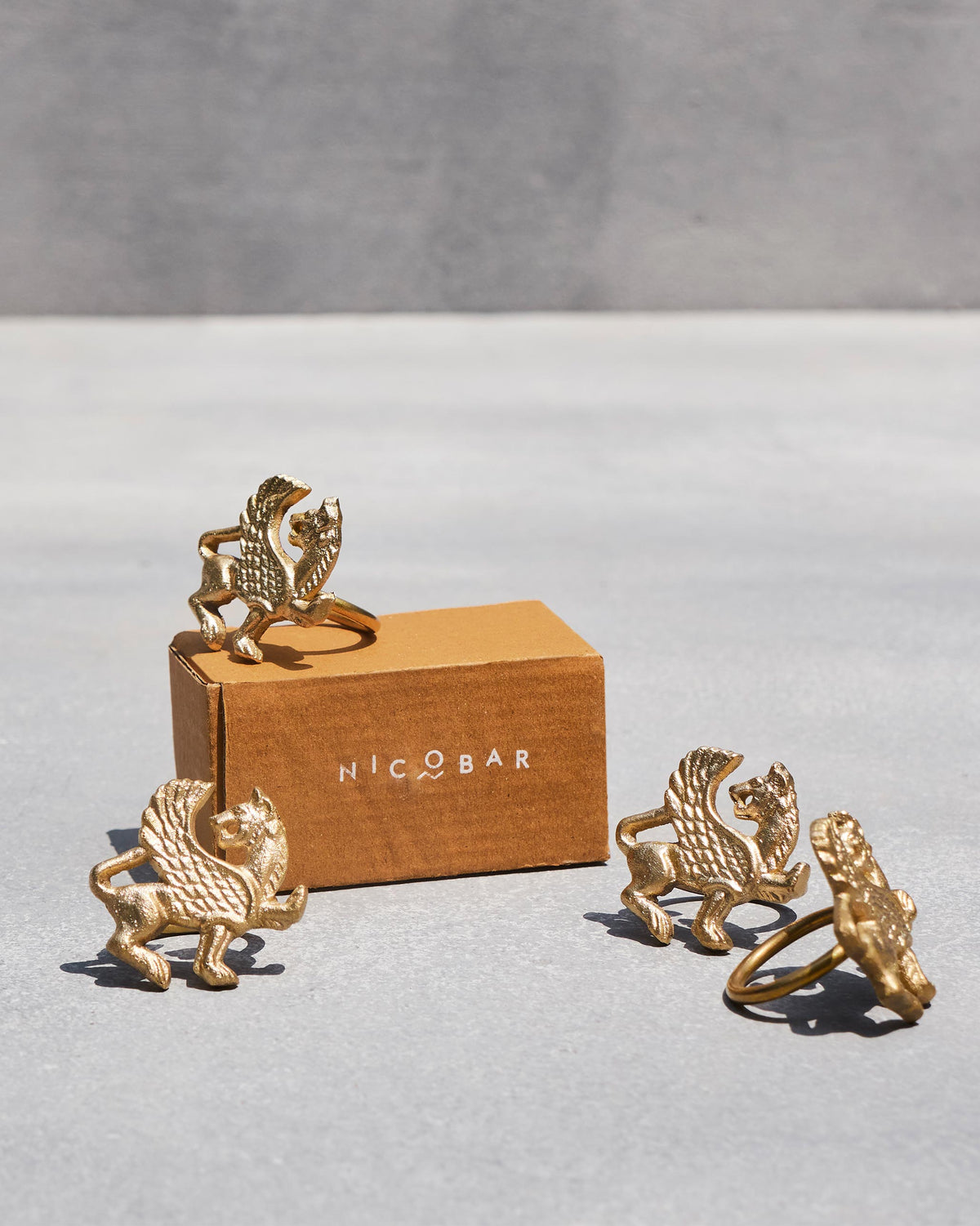Chinthe Napkin Rings on and beside a Nicobar box.