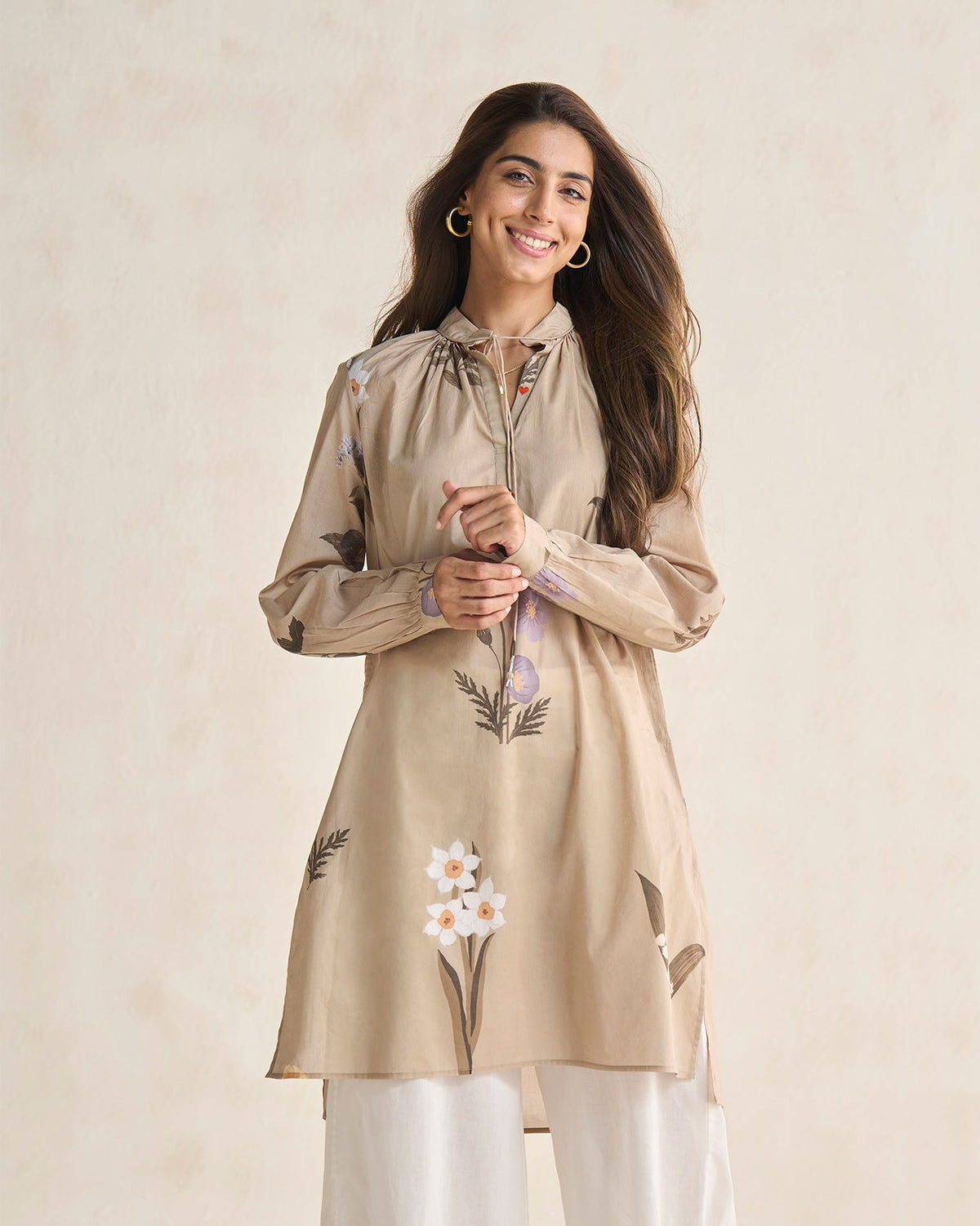 Person wearing a beige Boribo Highland kurta with a tie neckline.