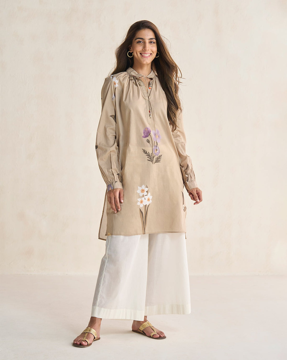 Person wearing a beige Boribo Highland kurta with lilac and white flowers.