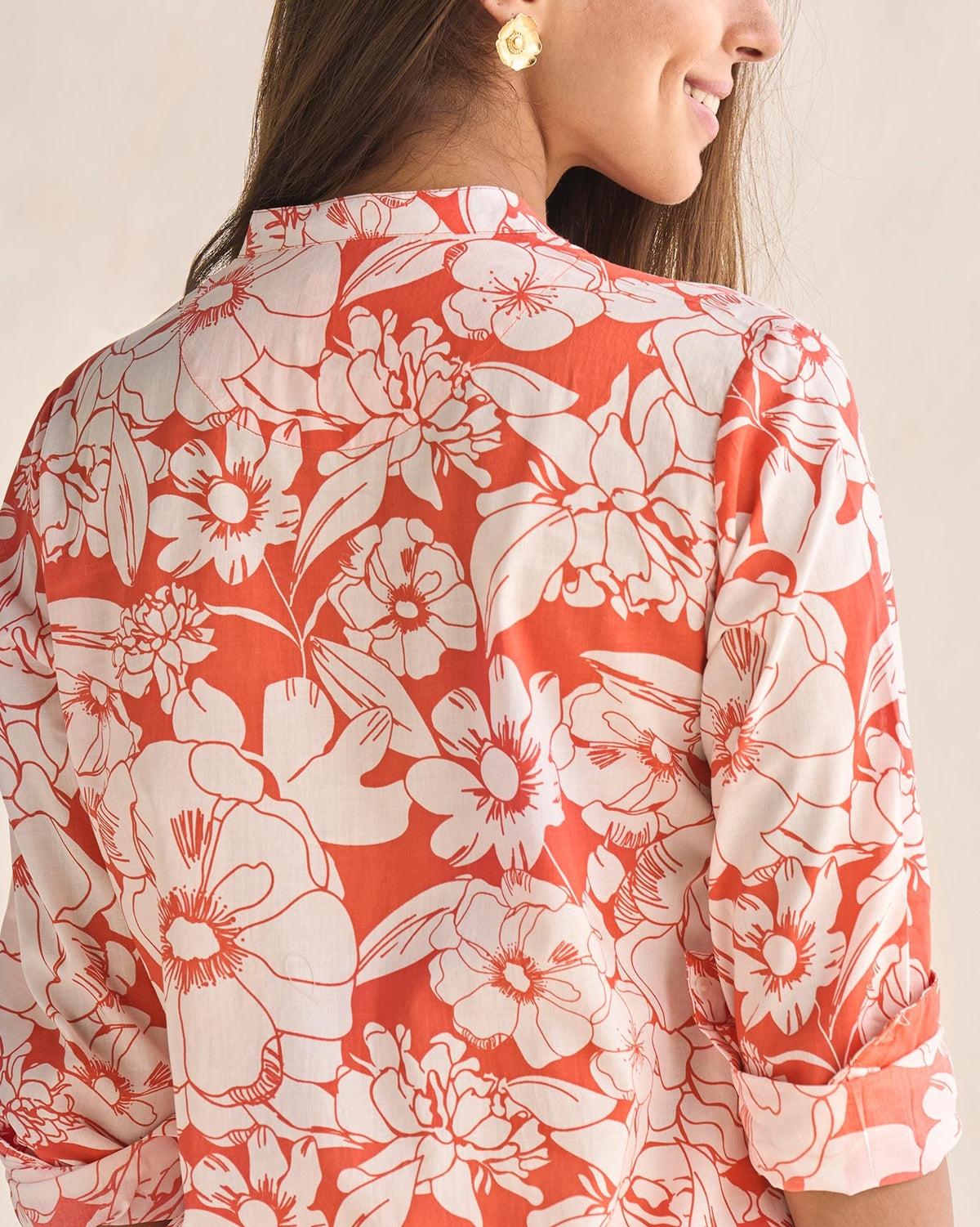 Close-up of the back of the coral and ivory Basic long length kurta showing its floral print.
