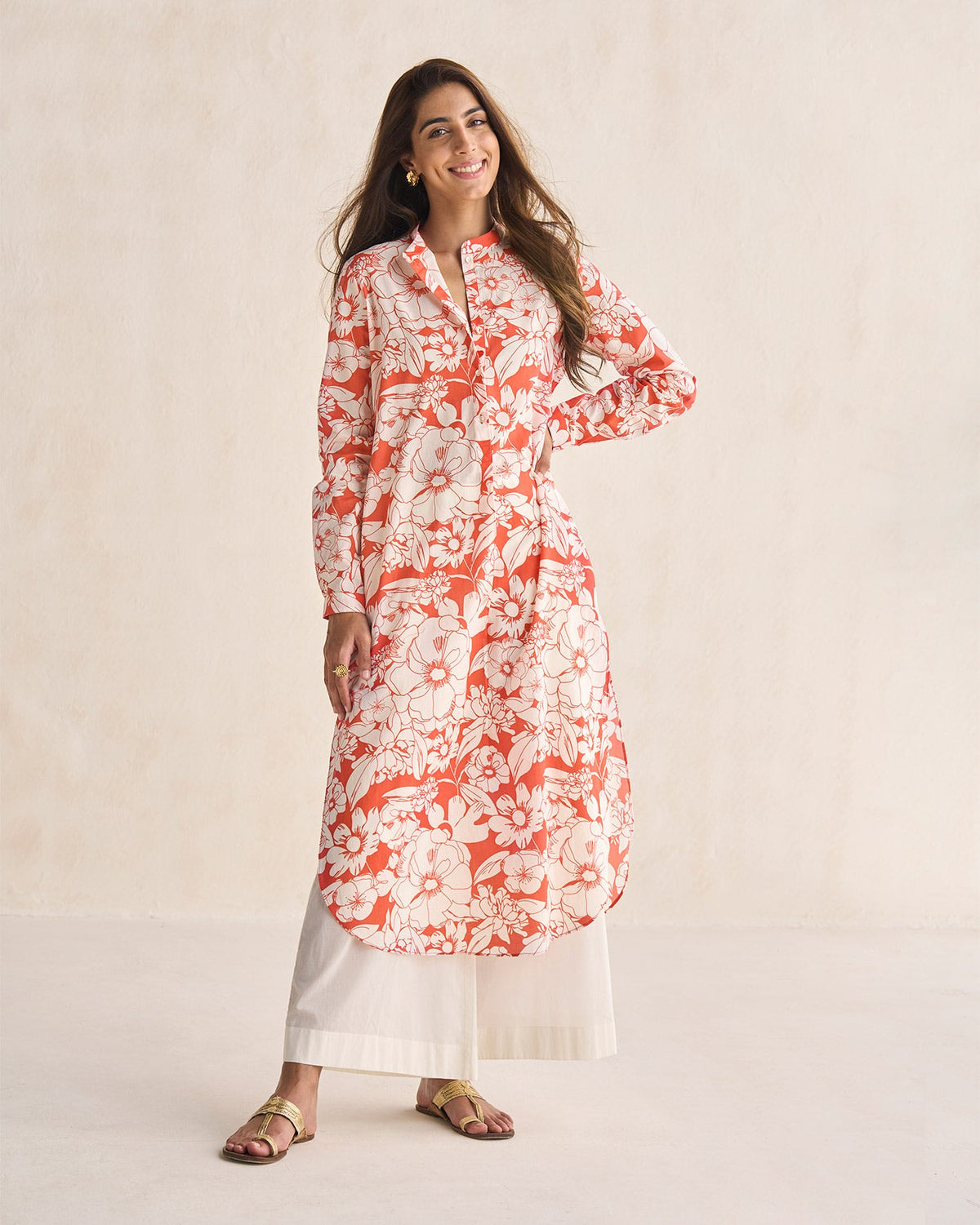Person standing in a coral and ivory Basic long length kurta with full sleeves.