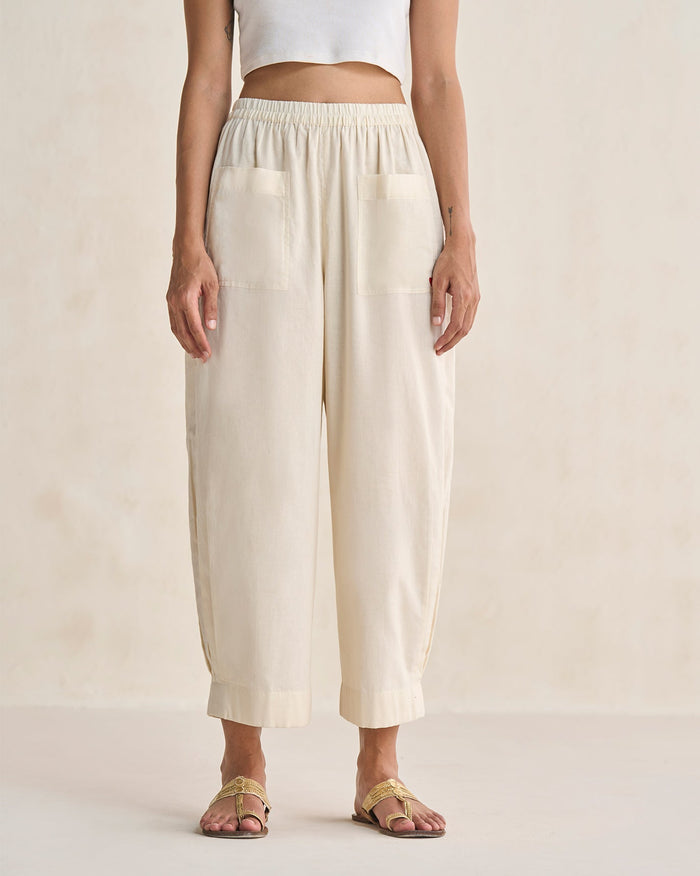 Person wearing Serene Pants in ivory with two front patch pockets.