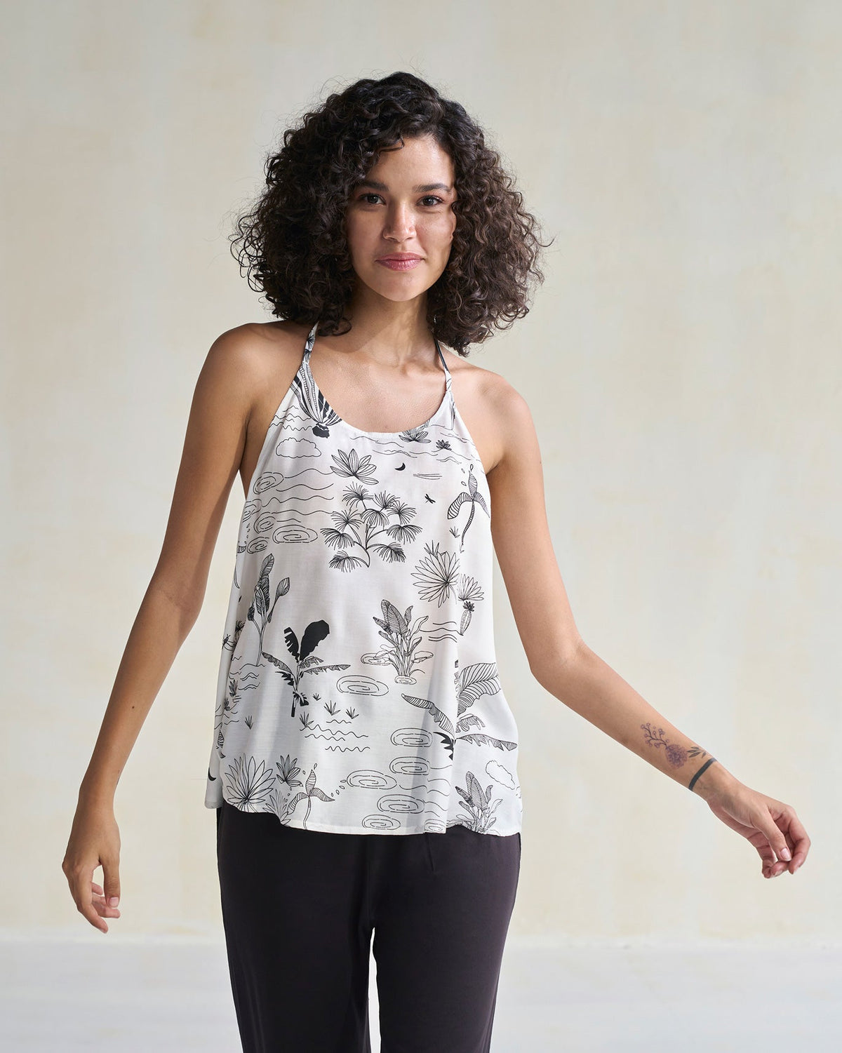 Person wearing an ivory Tranquila Camisole with a loose, relaxed fit.