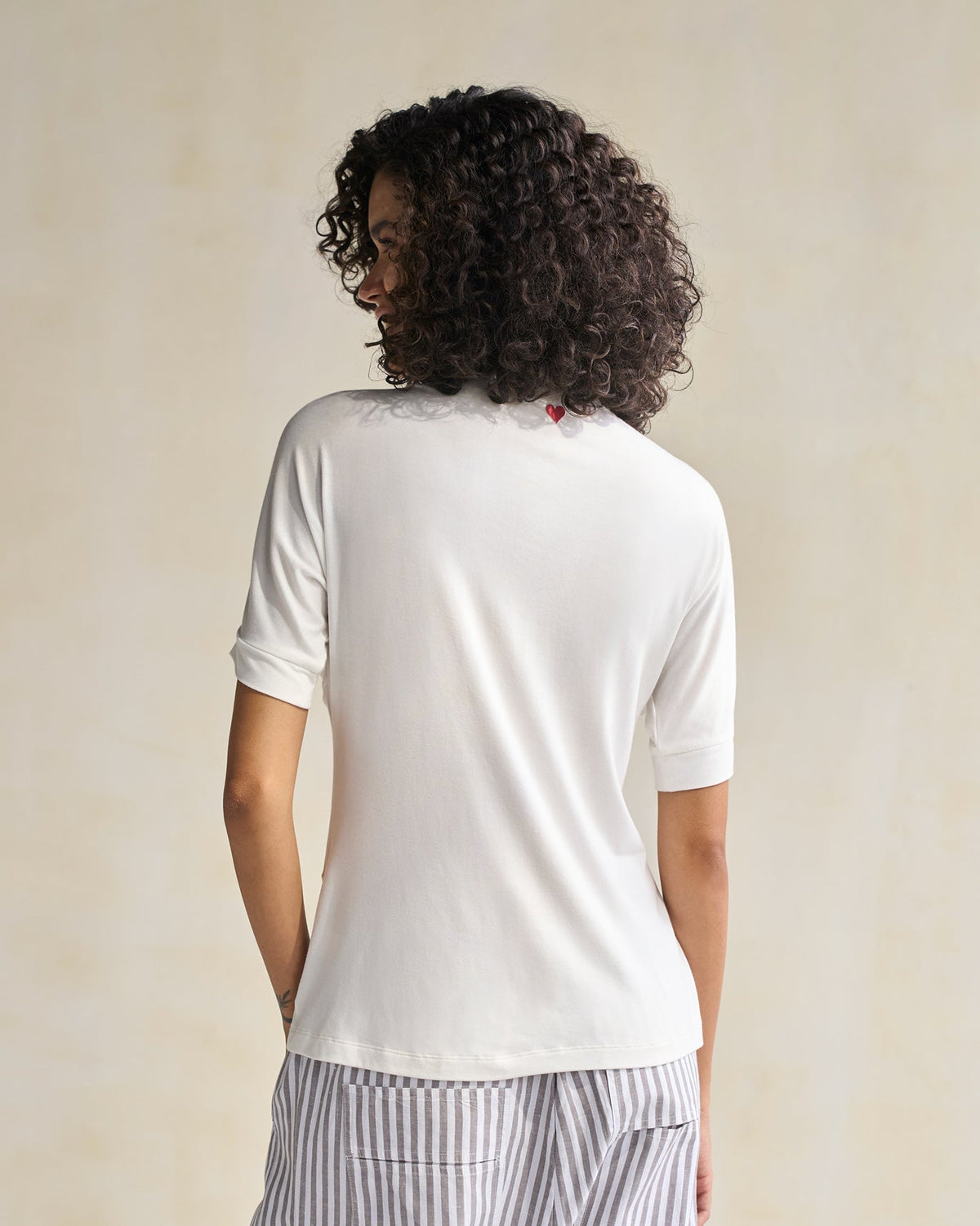 Back of an ivory Gathered Jersey Top worn by a person.