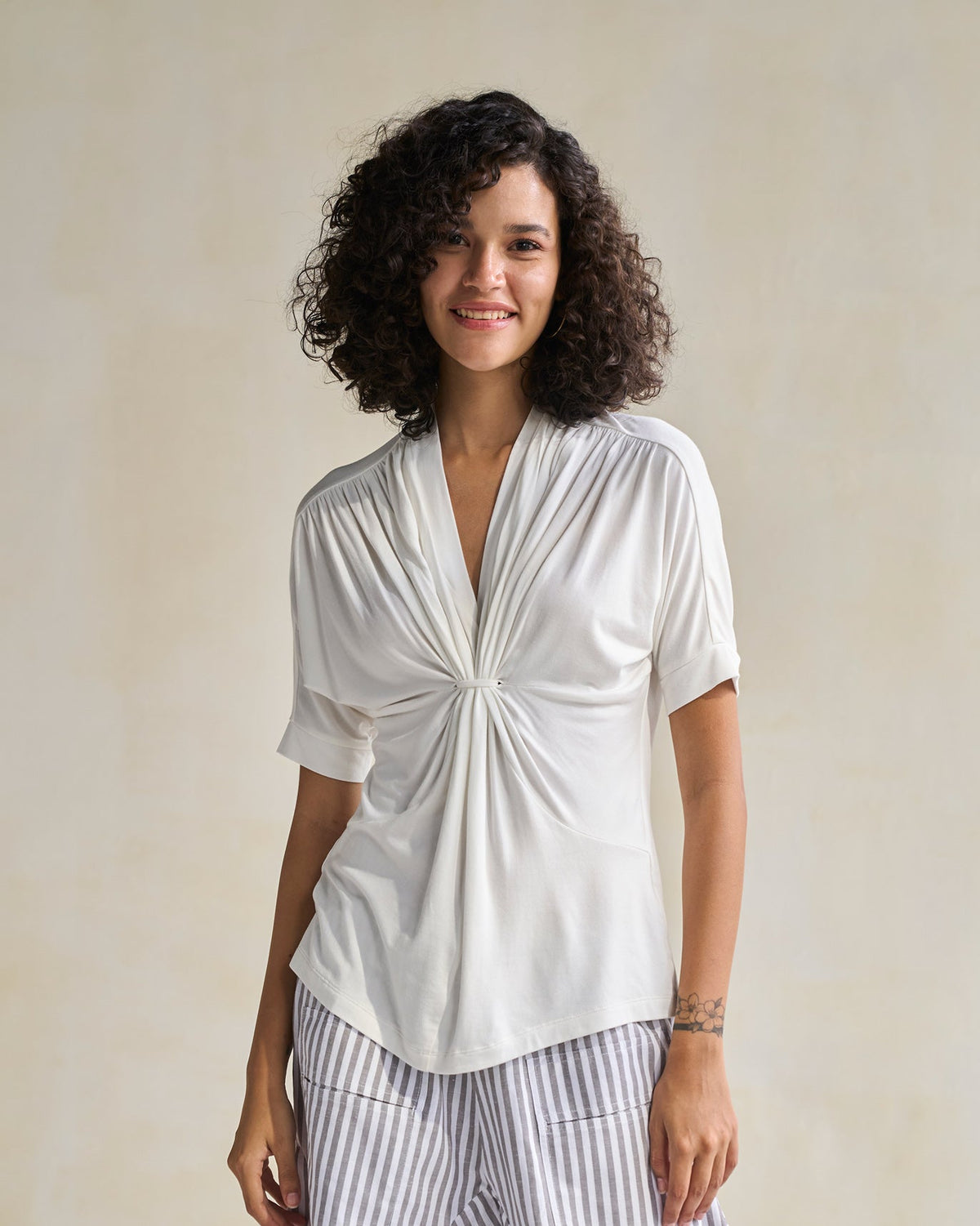 Front view of an ivory Gathered Jersey Top with a gathered V-neckline.