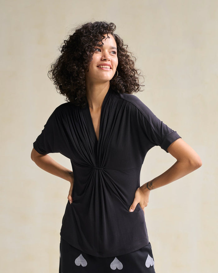 Person wearing a black Gathered Jersey Top with a gathered V-neck.