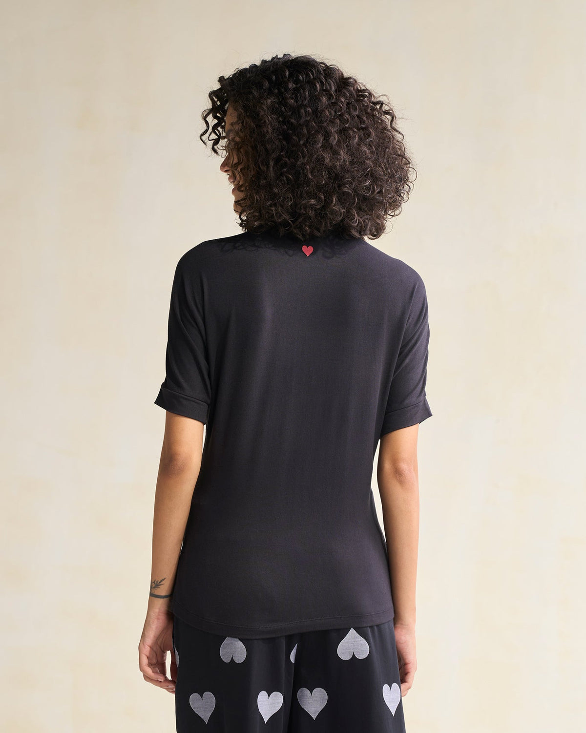 Back of a black Gathered Jersey Top worn by a person.