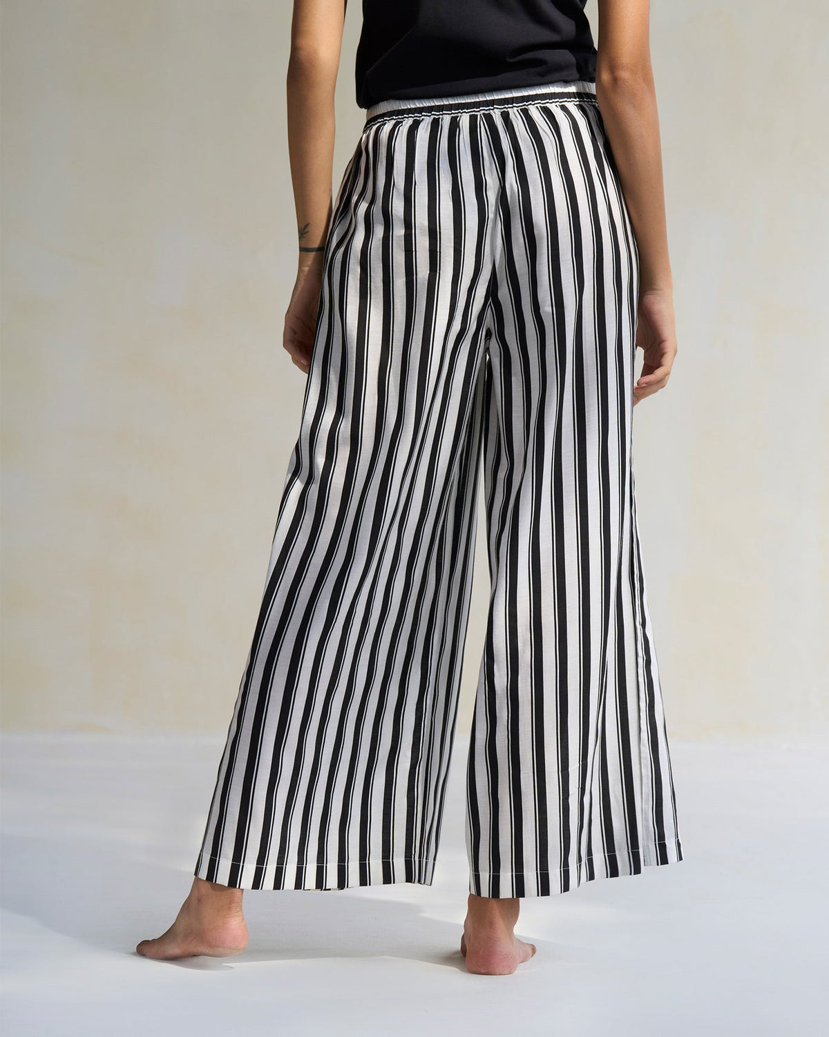 Back of black and ivory Celeste Pyjamas worn by a person.