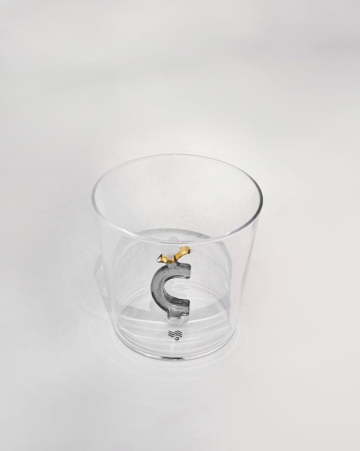 Clear tumbler with a 3D letter C topped by a tiny bee at the base.