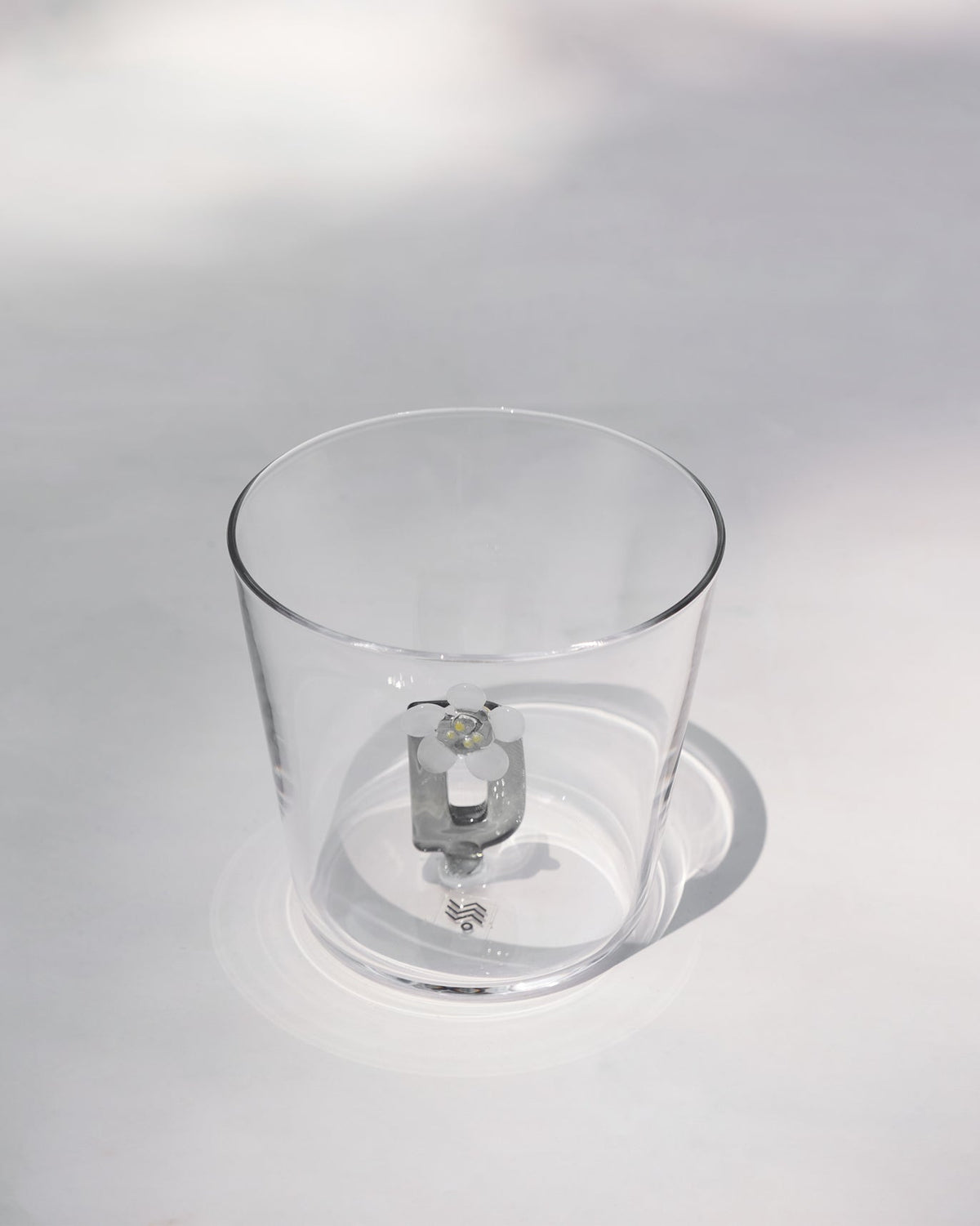 Clear tumbler with a 3D letter D topped by a white flower at the base.