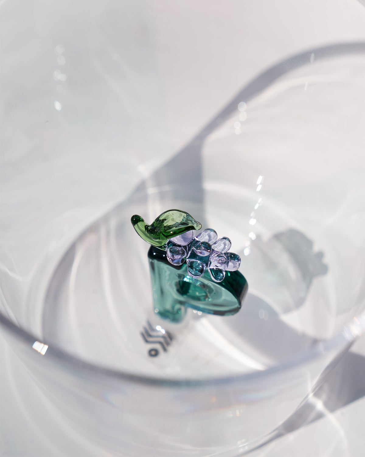 Close-up into Alphabet Glass P showing teal letter P with a purple flower.