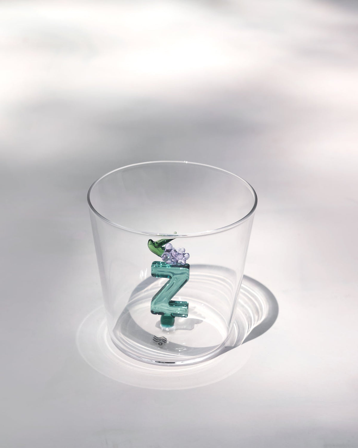 Clear Alphabet glass showing a teal letter Z with purple grapes at the base.