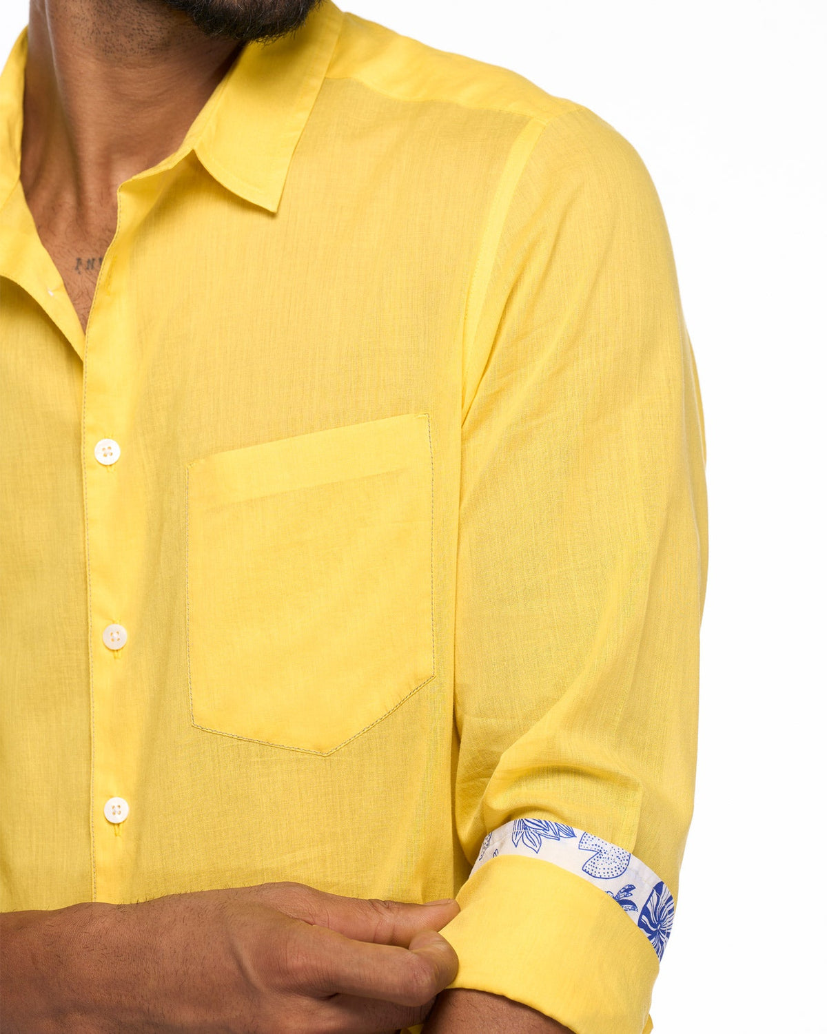Close-up of a yellow Sankara shirt sleeve showing a patterned cuff lining.