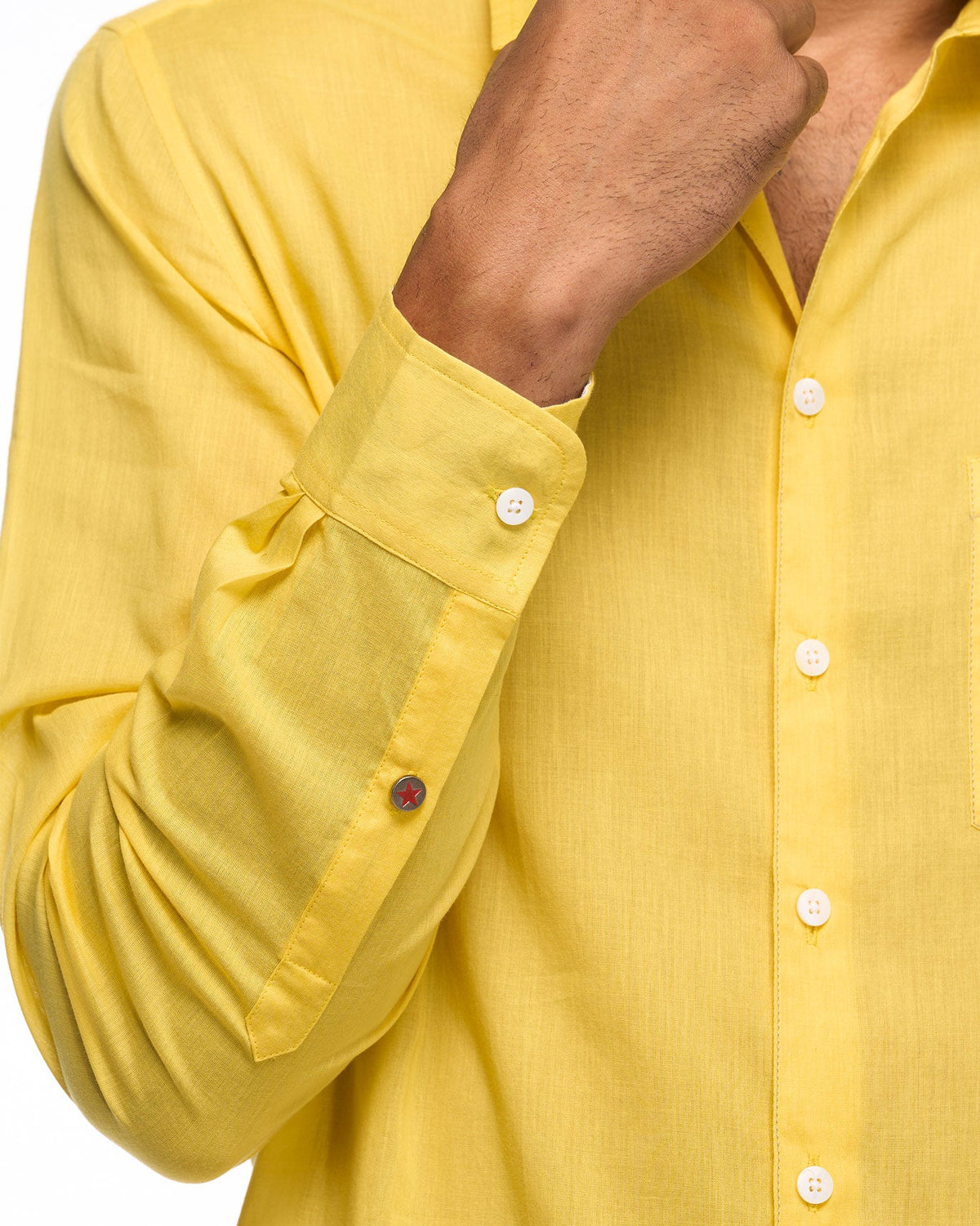 Close-up of a yellow Sankara shirt sleeve and button cuff.