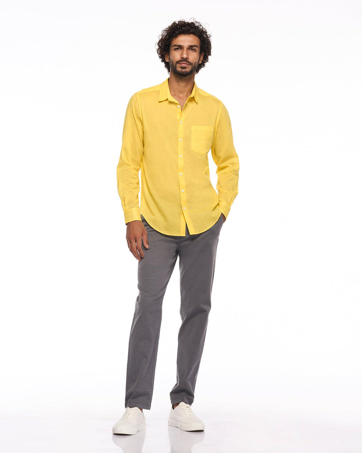 Full-length view of a yellow Sankara shirt worn by a person.