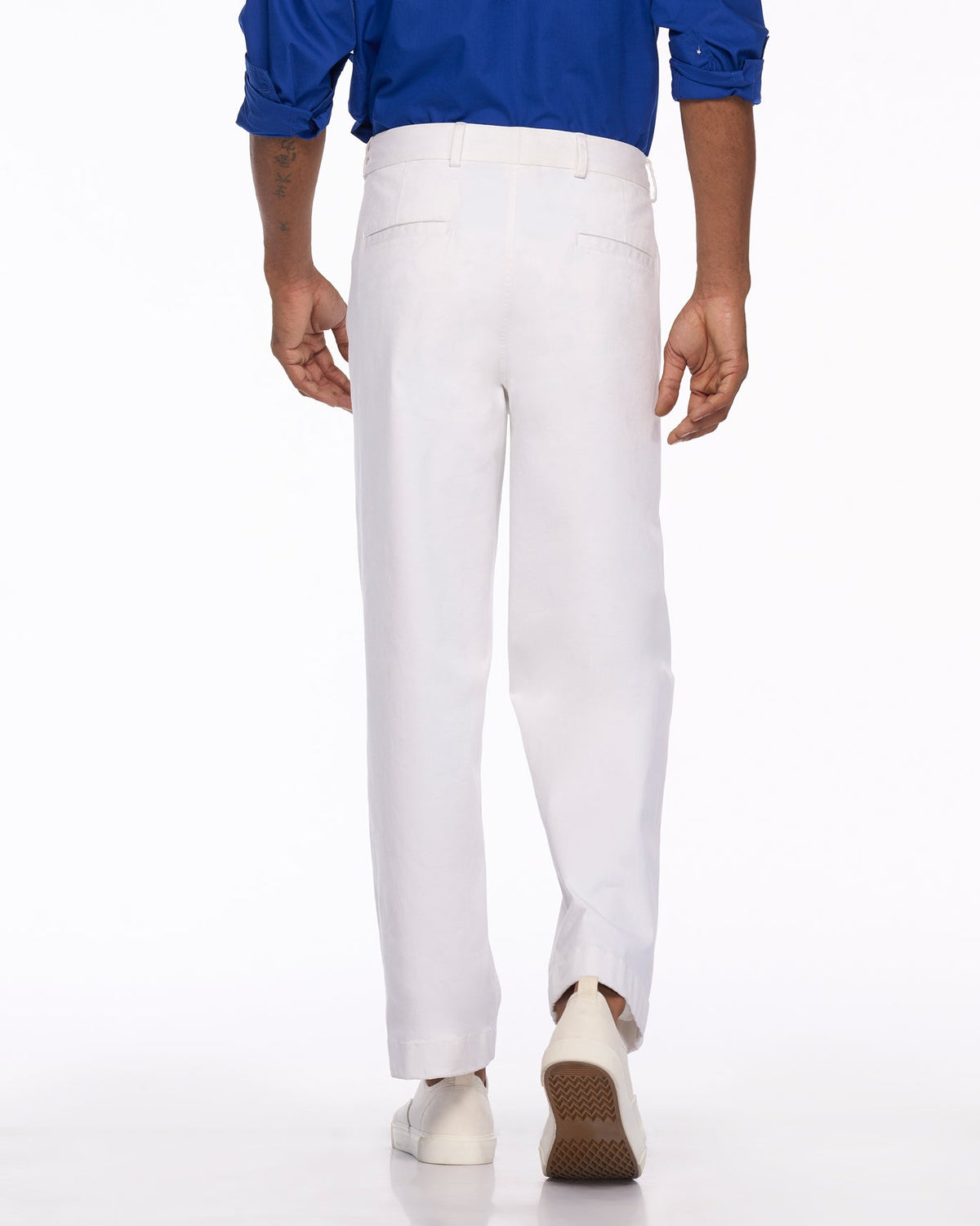 Back of white Sand Pants worn by a person, showing the back pockets.