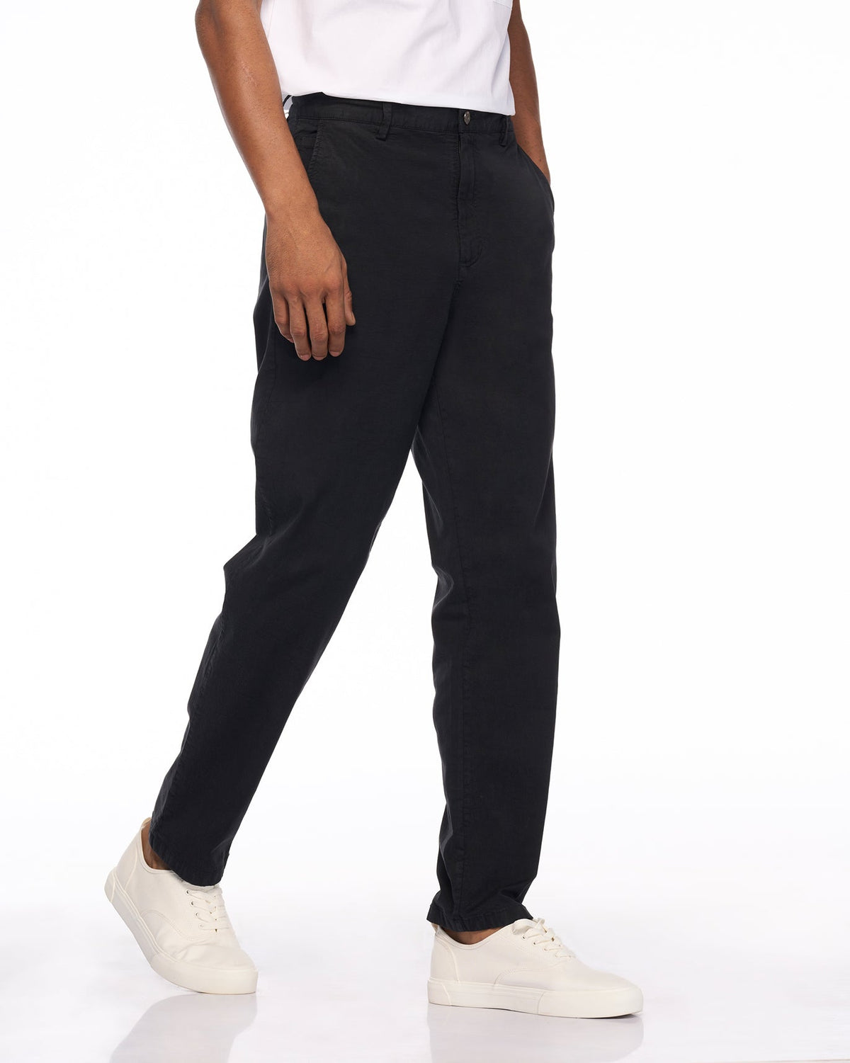Side view of black Azure Trousers worn by a person.