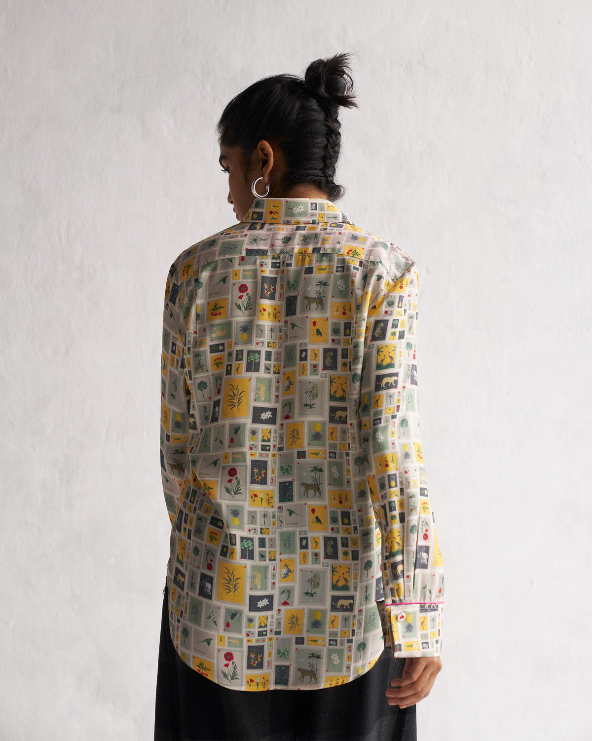 Back of a Basic Shirt in the animal and plant tile print, worn by a person.