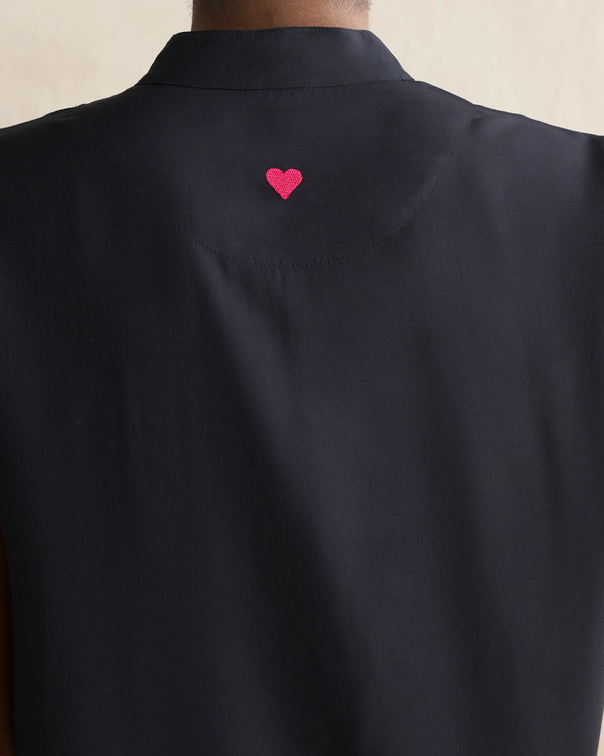 Back of a black Short Sleeve Kurta showing a pink heart embroidered at the neck.