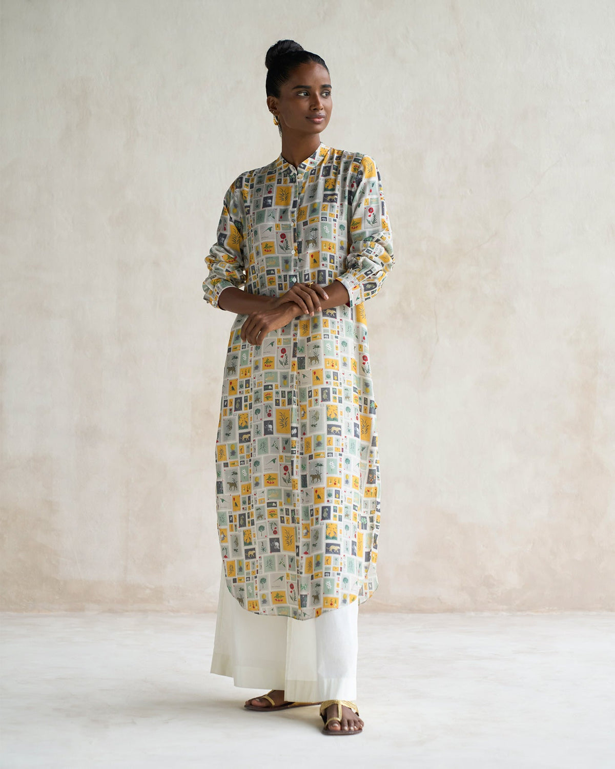 Person wearing a Basic long length kurta in a multicolour framed tile print.