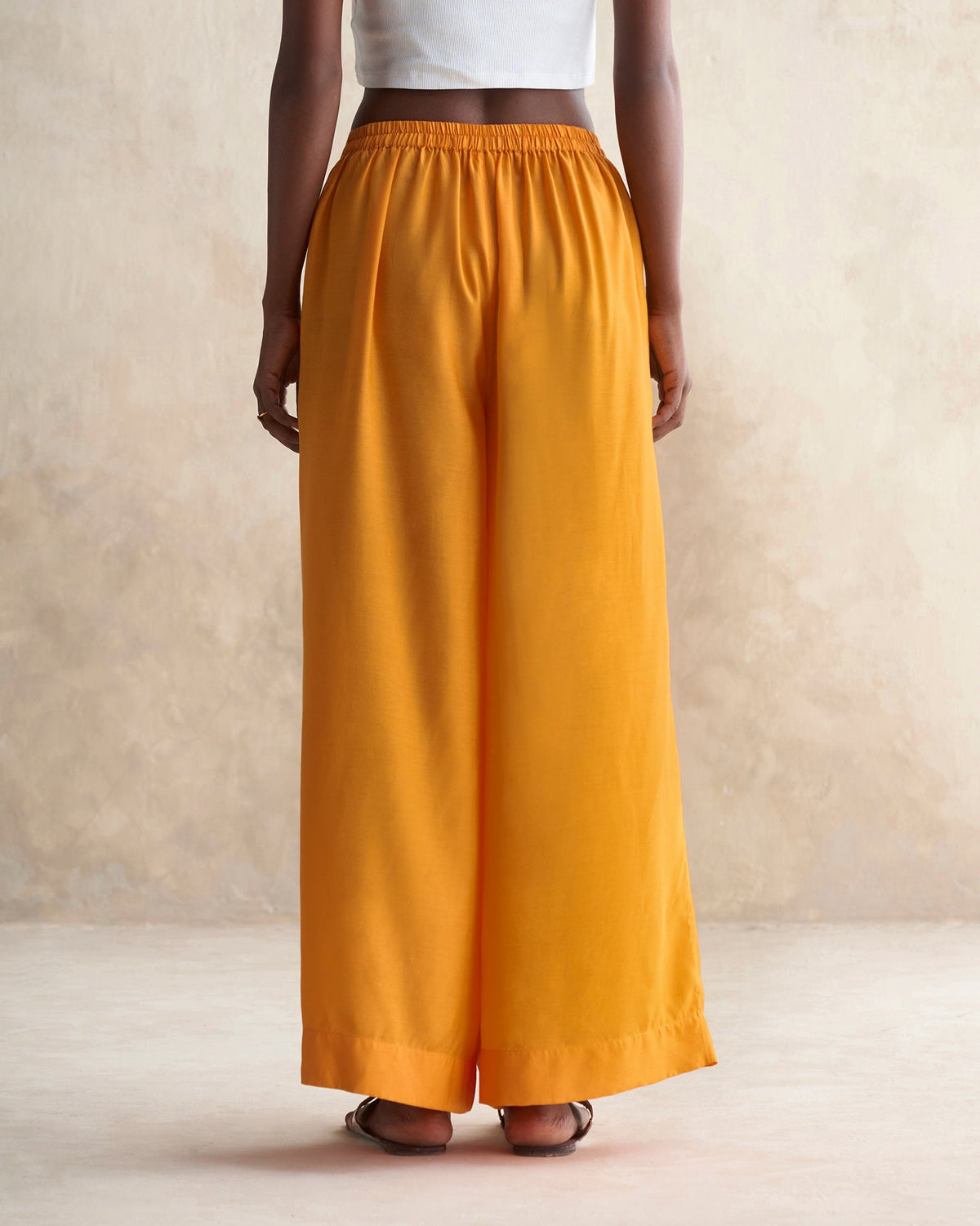 Back of tangerine Basic Pyjamas worn by a person.