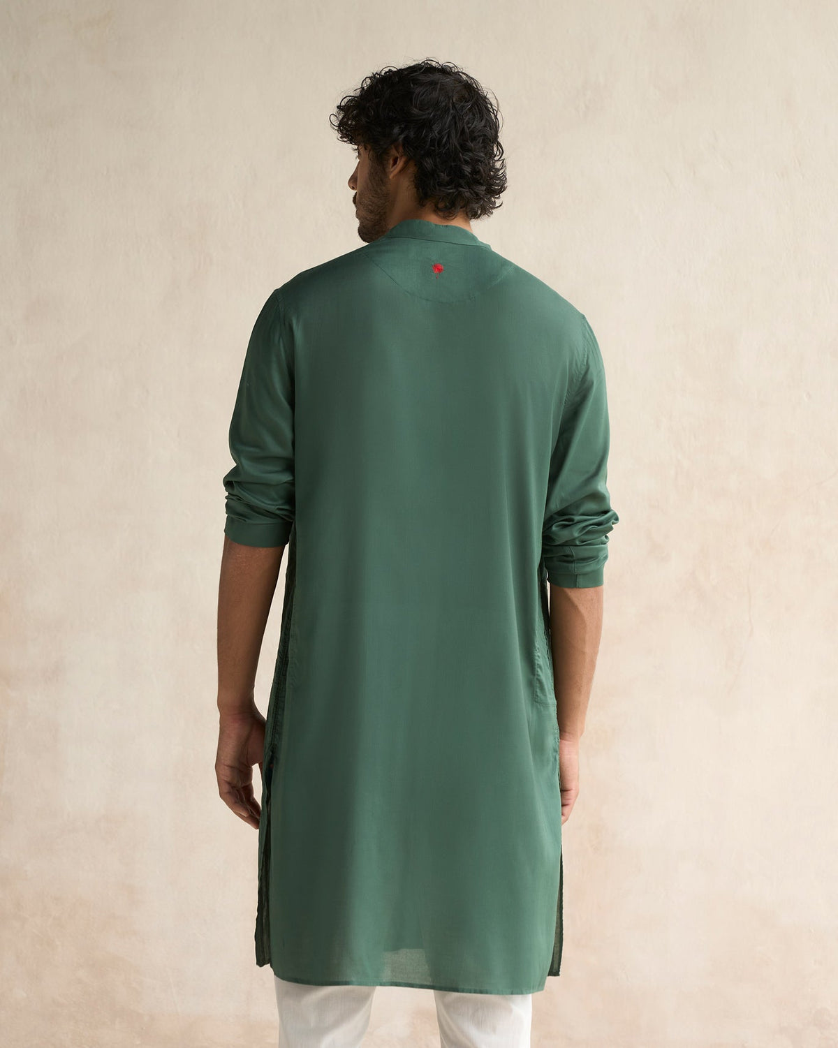 Back of a deep green Long Pleated Kurta worn by a person.
