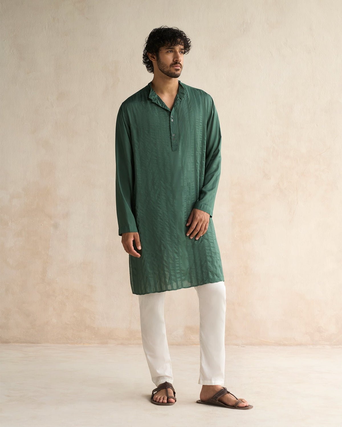 Full-length view of a deep green Long Pleated Kurta worn by a person.