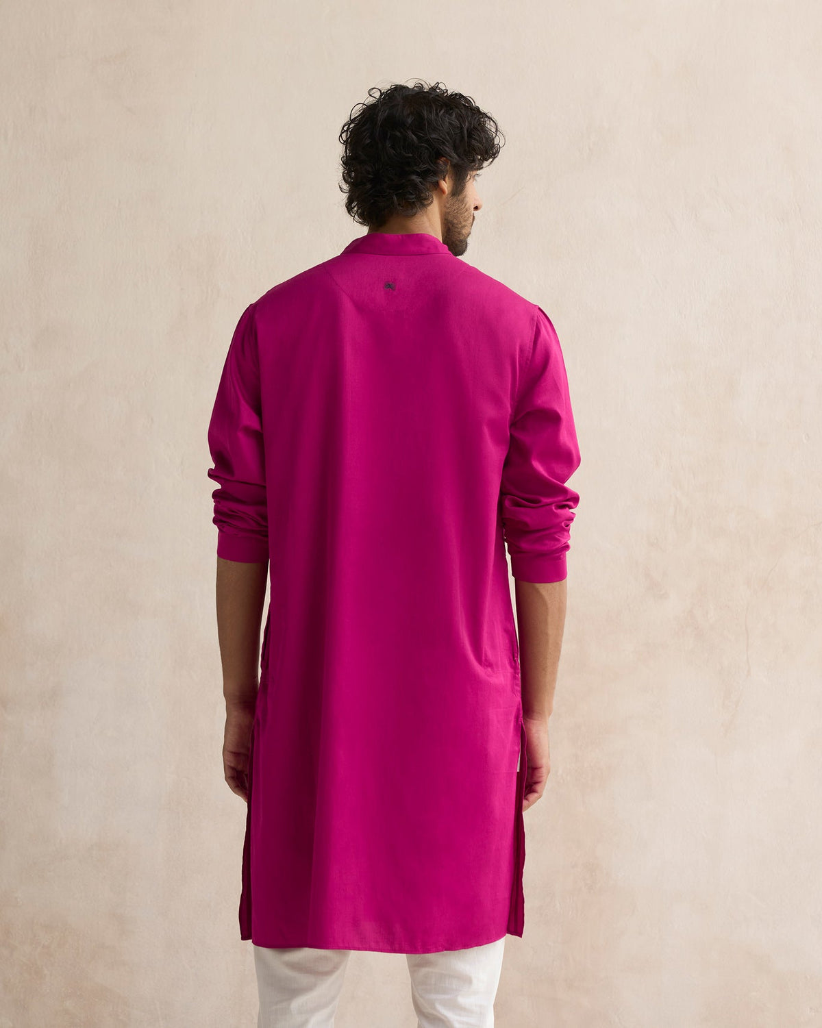 Back of a deep pink Long Pleated Kurta worn by a person.