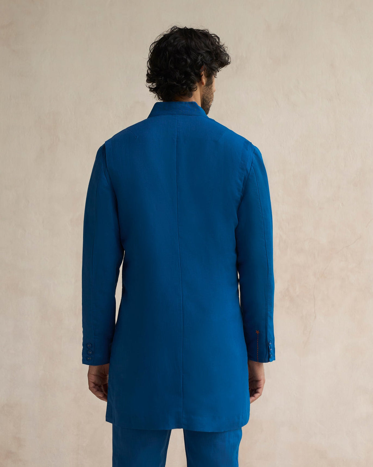 Back of a sapphire Negombo Bandhgala worn by a person.