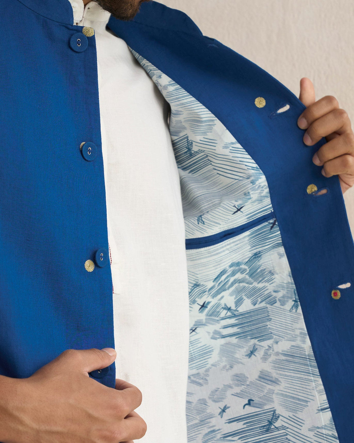 Close-up of a sapphire Nehru jacket opened to show its printed lining.