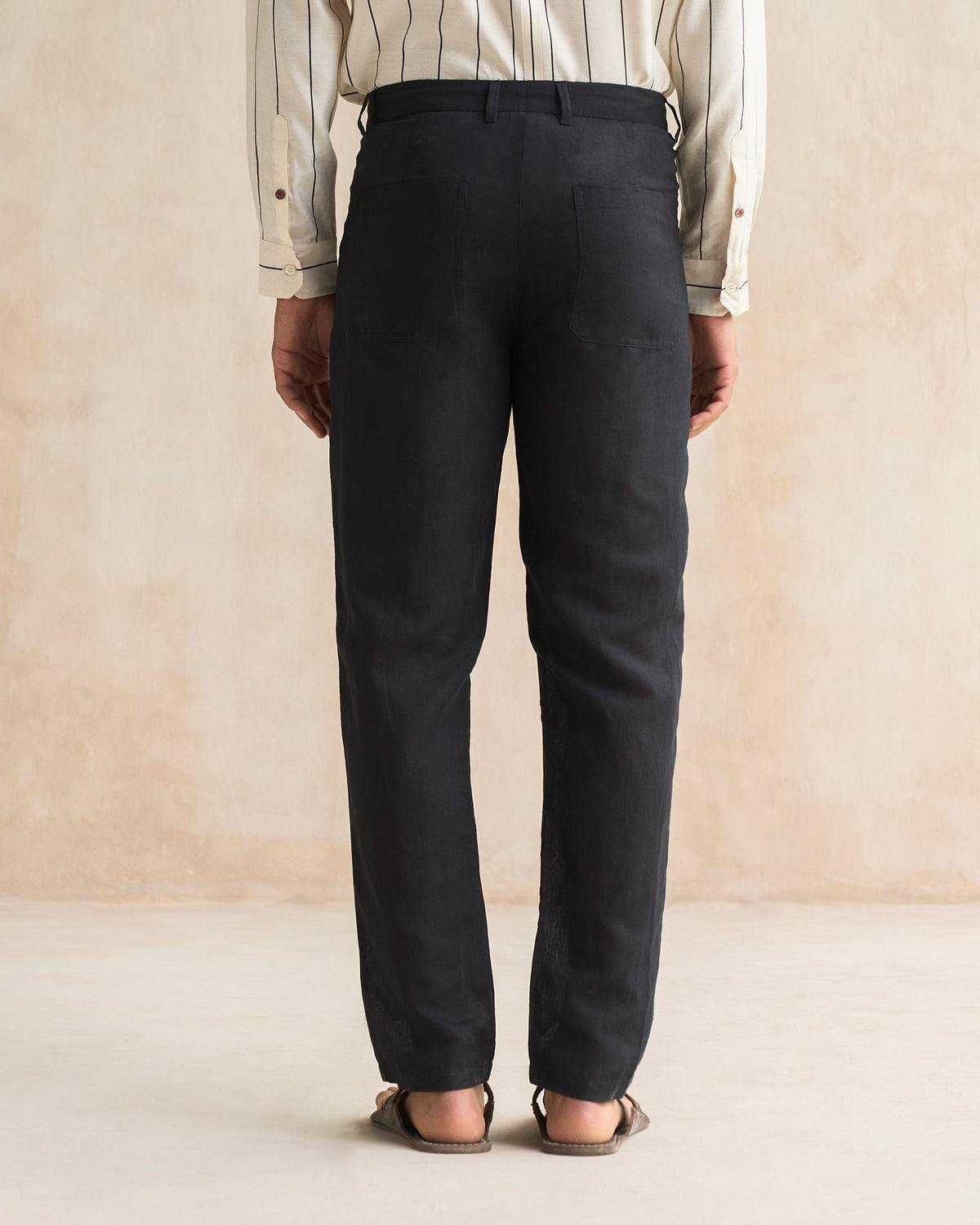 Back of black Serai Pants worn by a person.