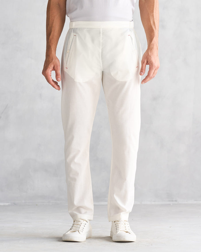 Person wearing ivory Kurta Pants with zip pockets at the front.