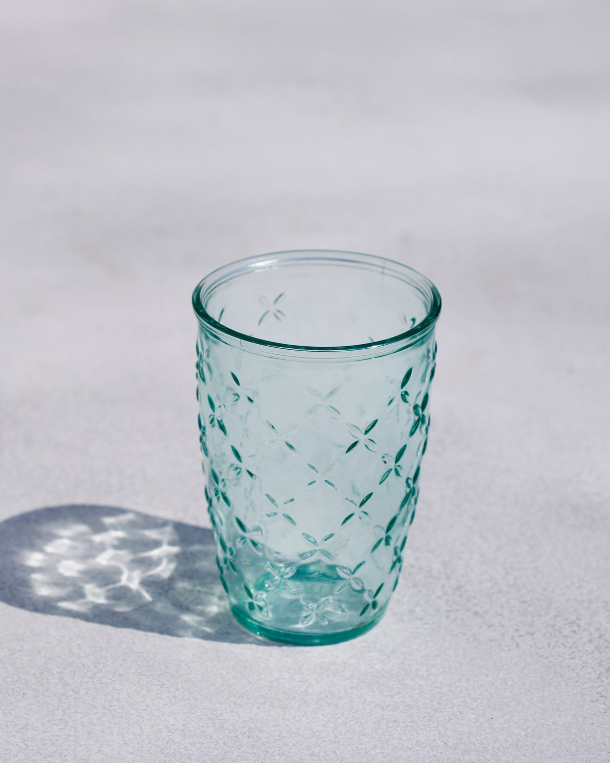 Twinkle Tumbler standing upright in pale green textured glass.