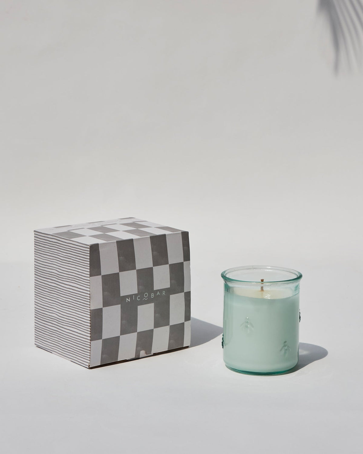 Firefly Candle beside its checkered gift box.