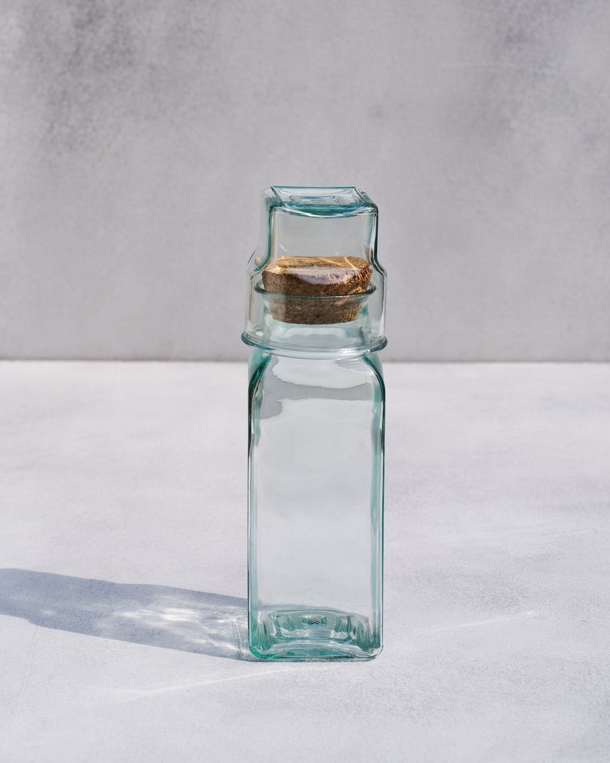 Ibis Tumbler & Carafe, a tall glass carafe with a cork stopper.