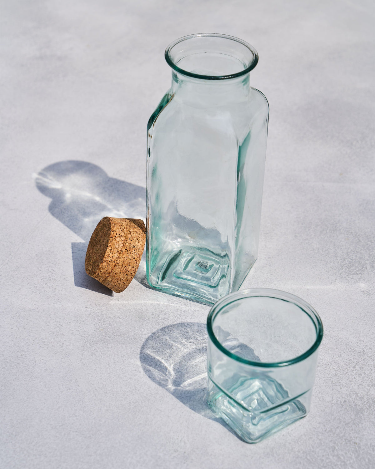 Ibis Tumbler & Carafe with its cork stopper lying beside the carafe.