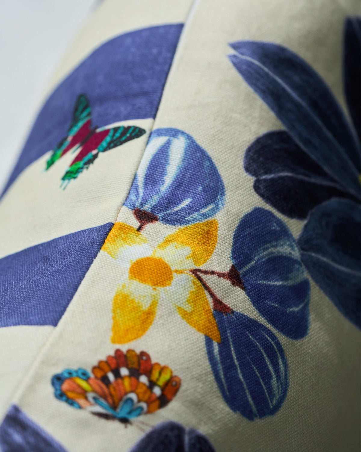 Close-up of the Bunga Lumbar Cover showing indigo and yellow flowers with butterflies.