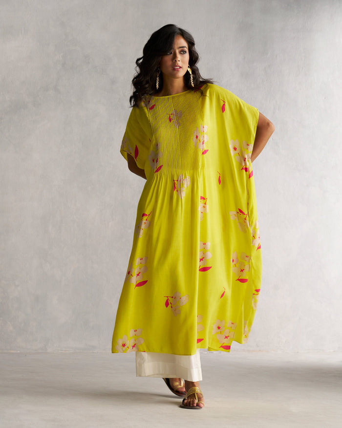 Person wearing Pintuck Kaftan in lime with a pin-tucked yoke and floral print.