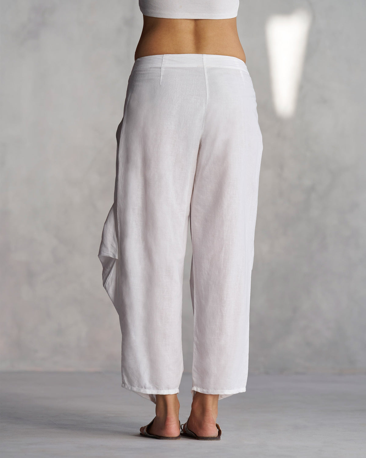 Back of Weekend Trousers in white worn by a person.