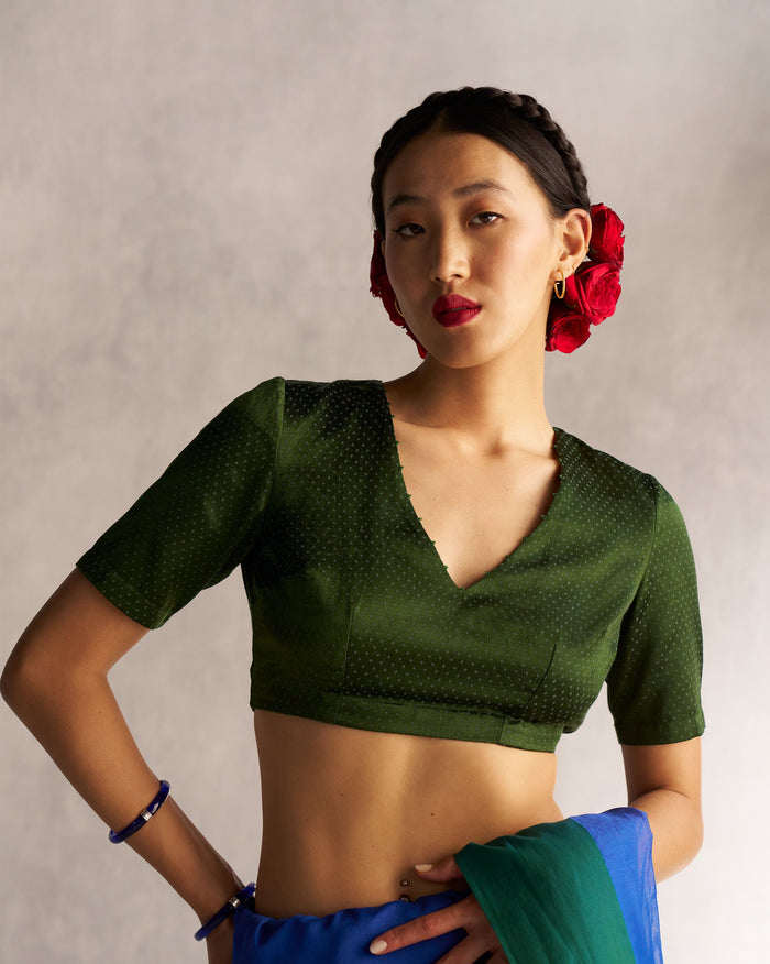 Person wearing a green Dori Blouse with a V-neck.
