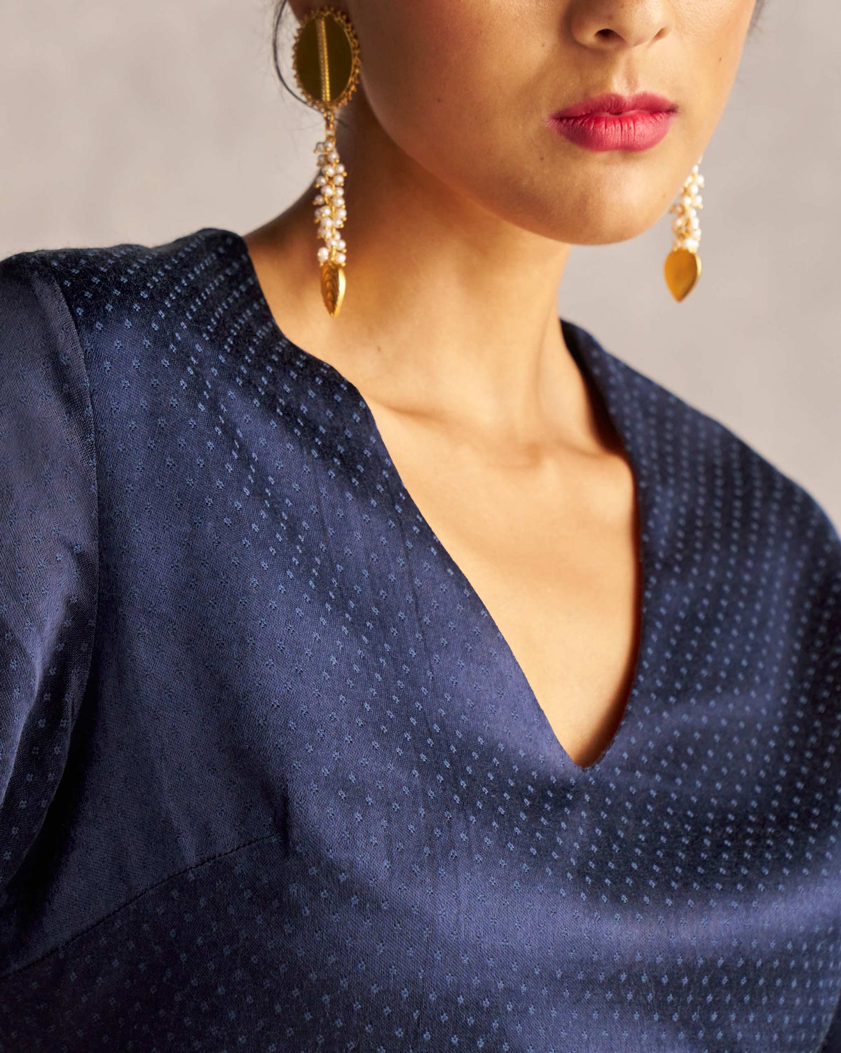 Close-up of Celestial Blouse showing its V-neck and subtle dotted weave.