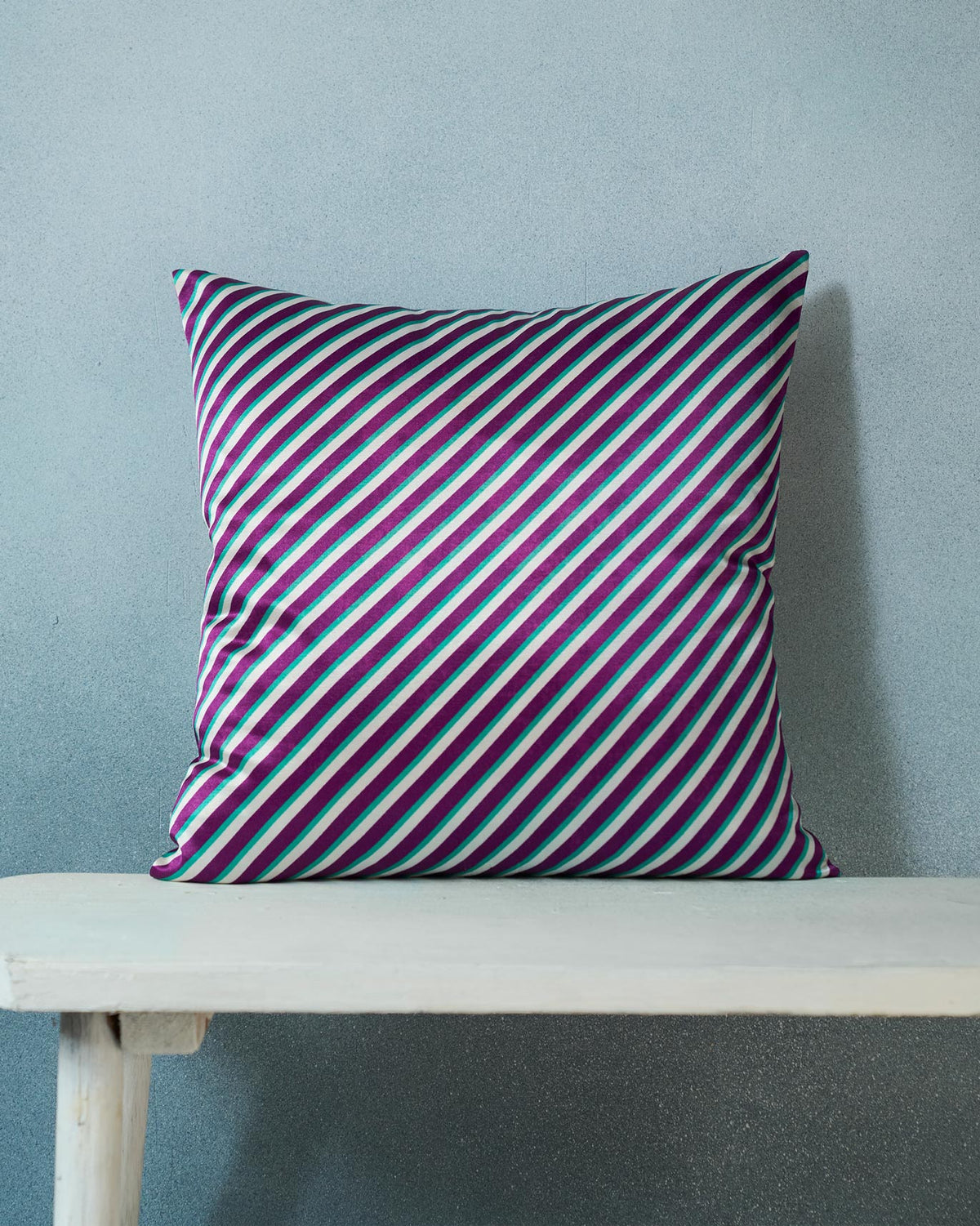 Back of the Barong Cushion Cover in purple and teal stripes.